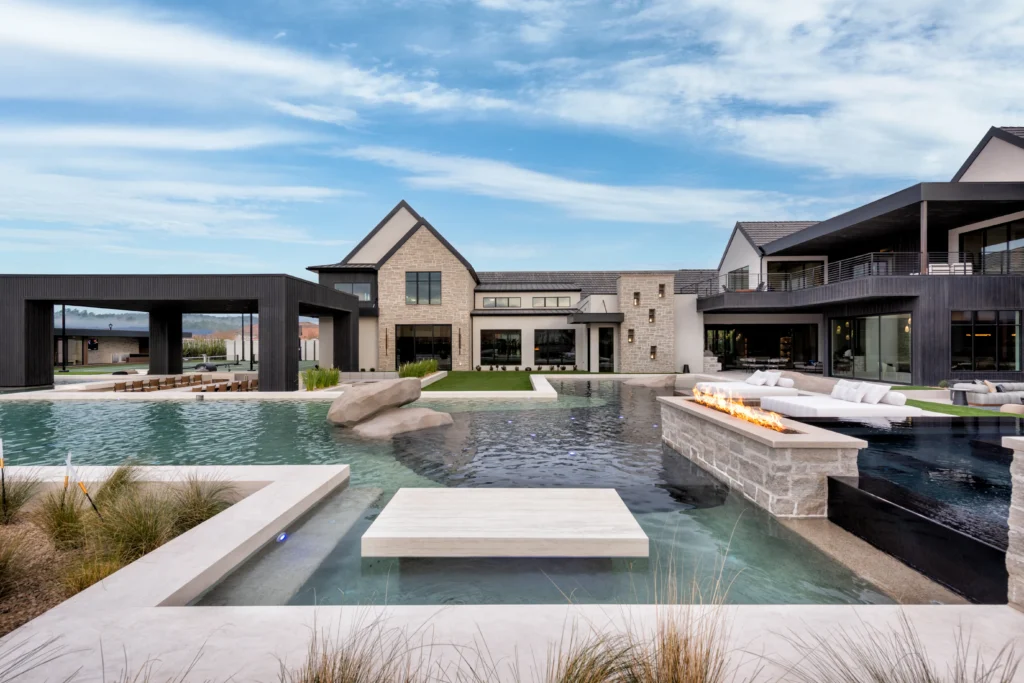 Custom swimming pool with an oversized in-pool dining table in a luxury Utah backyard